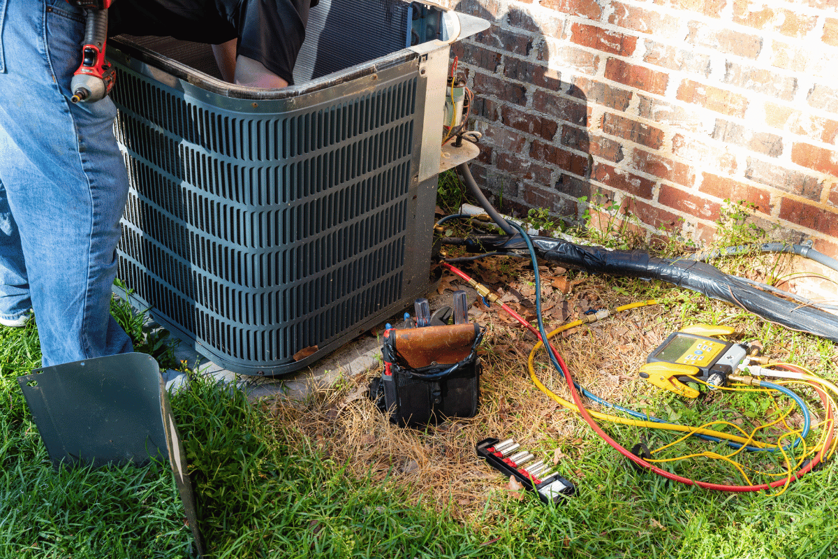 Technician repairing an AC unit